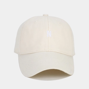 Close-up of premium white cotton baseball cap with detailed white N letter embroidery