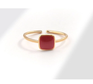 Detail shot of vintage golden open ring featuring a square red enamel centerpiece