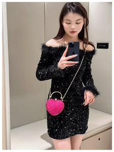Mirror selfie showing heart-shaped pink rhinestone evening clutch with gold metal handle