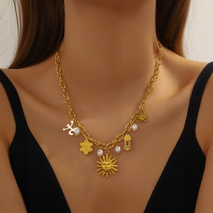 Vintage gold-plated stainless steel necklace with sun pendants and pearls on a model