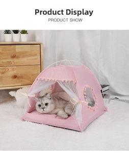 Pink polka dot pet tent with lace curtains and a grey cat resting on a soft inner cushion