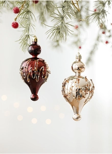Macro detail of luxury onion-shaped Christmas ornaments with glitter and sequins on branches