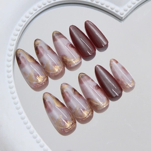 Chic 3D cat eye amber press on nails with gold foil and marble smudge effect