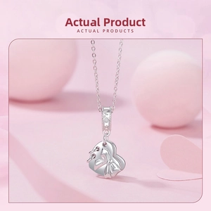 Detail showing an S925 silver heart charm with bowknot and celestial engraving motifs