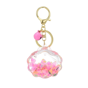 Luminous seashell oil keychain with pink sequins, fruit slices, and golden bell