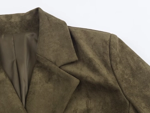 Detailed close-up of olive green faux suede jacket lapel and shoulder tailoring