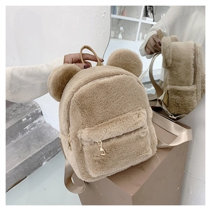 Detailed view showing plush beige backpack with cute bear ears and smooth metal zipper