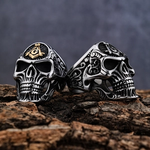 Gothic viking skull ring in retro silver with golden masonic symbol on textured bark