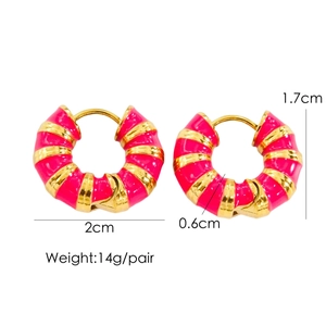 Close-up of golden hoop earrings with pink enamel twisted rope design and sizing info