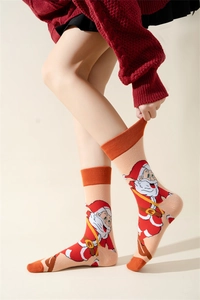 Detail of knitted Christmas socks with Santa Claus pattern on beige background