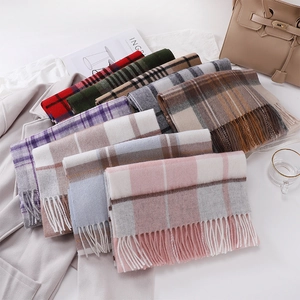 Close-up of stacked Australian wool scarves featuring diverse plaid patterns and tassel edges