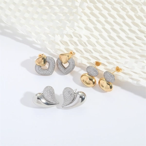 Romantic gold heart and leaf drop earrings with sparkling cubic zirconia on white background
