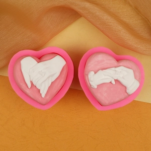 Detailed pink silicone mold for 3D heart-shaped hand-holding candles and DIY crafts