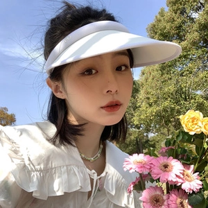 Outdoor shot of a breathable white sun visor hat providing UV protection for women