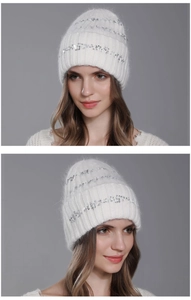 Detail of white rabbit fur knit beanie with shiny sequins and warm ear protection