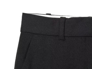 Detailed close-up of high-quality black woven fabric on the waistband and belt loops