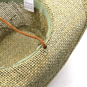 Detailed macro view of 100% paper straw hat interior with sweatband and wind rope