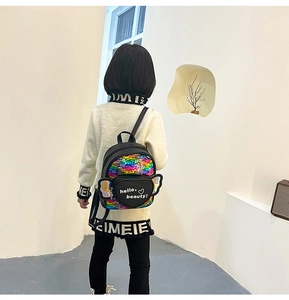 Detail view of a black sequin girls backpack with rainbow wings and heart pocket