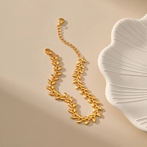Detailed close-up of 18K gold plated wheat leaf chain bracelet with lobster clasp