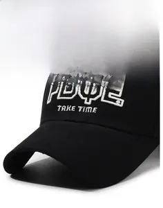 Detailed macro view of black cotton baseball cap featuring 3D embroidered white lettering