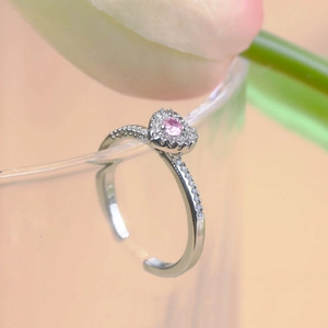 Detail of silver adjustable heart ring with pink zircon and micro-pave setting