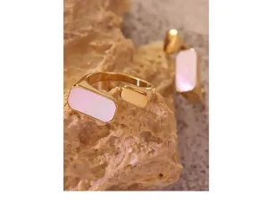 Detailed macro view of 18K gold plated ring with pink shell inlay on stone