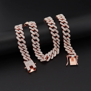 Detailed close-up of rose gold Cuban link jewelry set with sparkling rhinestones on black stand