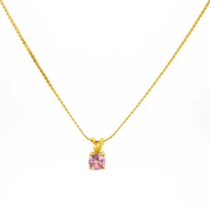 Close-up of pink round-cut birthstone pendant on 18K gold-plated stainless steel chain