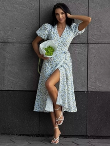 Close-up of white floral cotton dress showing V-neck and puff sleeves detail