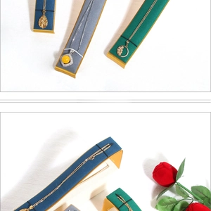 Detailed view of curved microfiber necklace display stands with solid wood bases and roses
