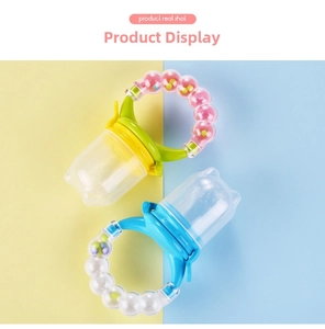 Detail of baby silicone food feeders with rattle handles in pastel blue and green colors