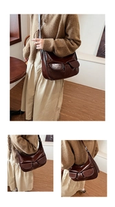 Detail view of retro brown crossbody bag with dual pockets and glossy leather finish