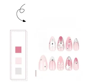 Detail of pink gradient almond nails with silver bow and star rhinestone decorations