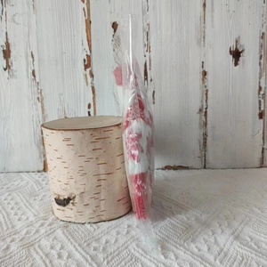 Detailed view of red and white knit wine bottle sweater packaged in a clear bag