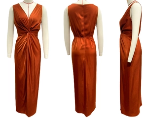 Detail view of the rust orange sleeveless satin dress with twist front waist and v-neck
