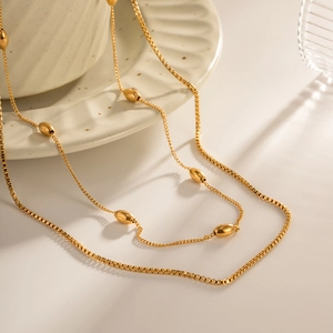 Double-layered 18k gold plated stainless steel necklace featuring oval beads and fine chains
