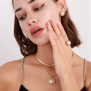 Elegant gold pearl jewelry set including necklace, earrings, and ring for women