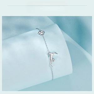 Detail of S925 sterling silver chain bracelet with cute cat silhouette and paw print pendants