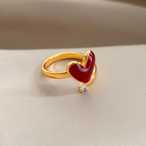 Macro side view of 18k gold plated open ring with red enamel heart and zircon stone