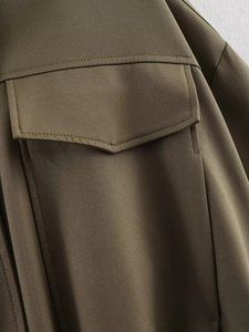 Close-up detail of the army green twill jacket featuring a front flap pocket and neat stitching