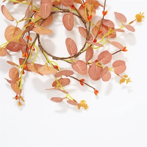 Harvest festival candle ring with orange berries and eucalyptus leaves on white background