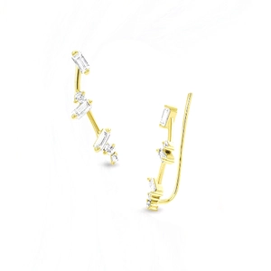 Macro shot of gold-plated C-shaped earrings with sparkling cubic zirconia crystals