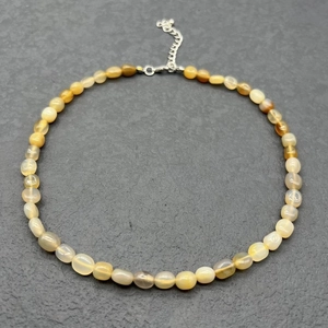 Detailed close-up of natural agate beaded necklace with silver lobster clasp and extension chain