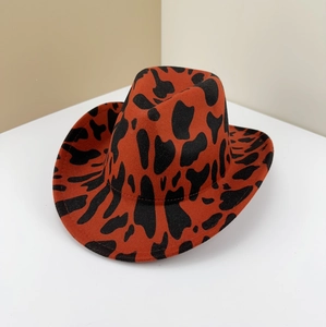 Western style cow pattern felt cowboy hat in vibrant orange with black cow spots