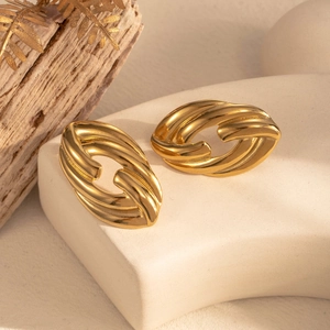 Elegant gold twisted oval stud earrings made of titanium steel on a premium display