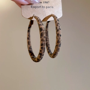 Close-up of vintage leopard print flocked hoop earrings with retro aesthetic details
