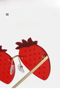 Macro detail of red strawberry sunglasses with gold metal frame and adjustable nose pads