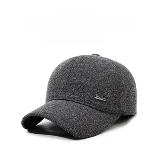 Detail view of winter baseball cap with dark grey texture and fashion metal badge