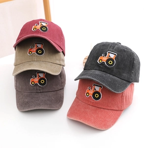 Five assorted children's washed cotton baseball caps with tractor embroidery on white background