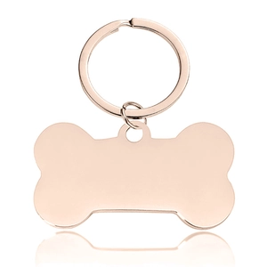 Detailed macro view of bone-shaped rose gold stainless steel pet tag with smooth finish